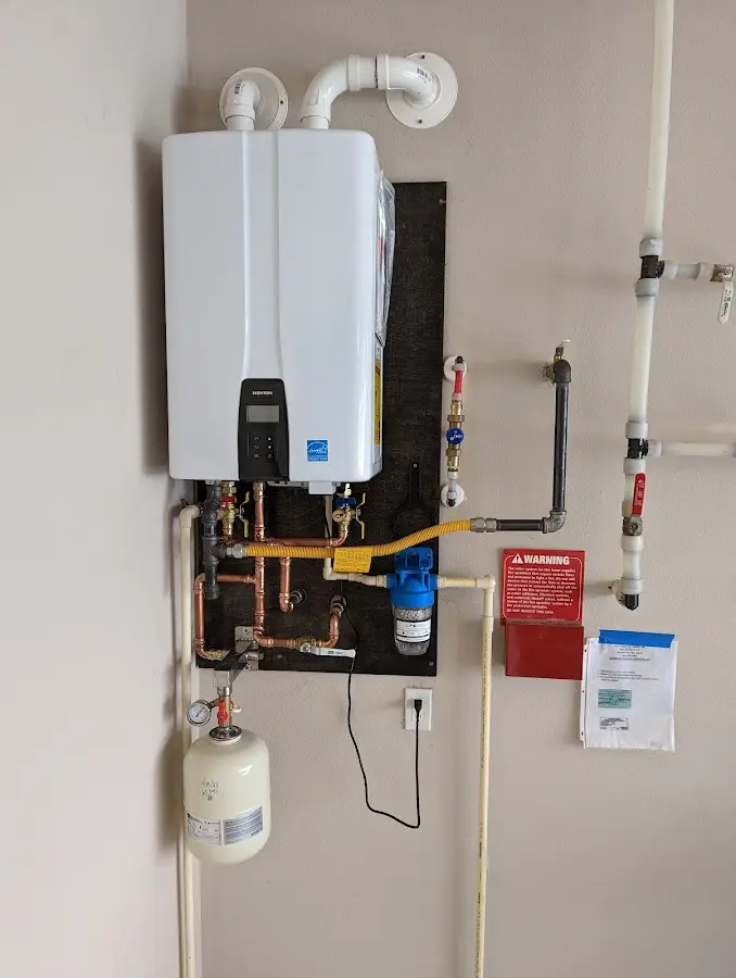 Professional plumber installing copper piping in a Mount Prospect home